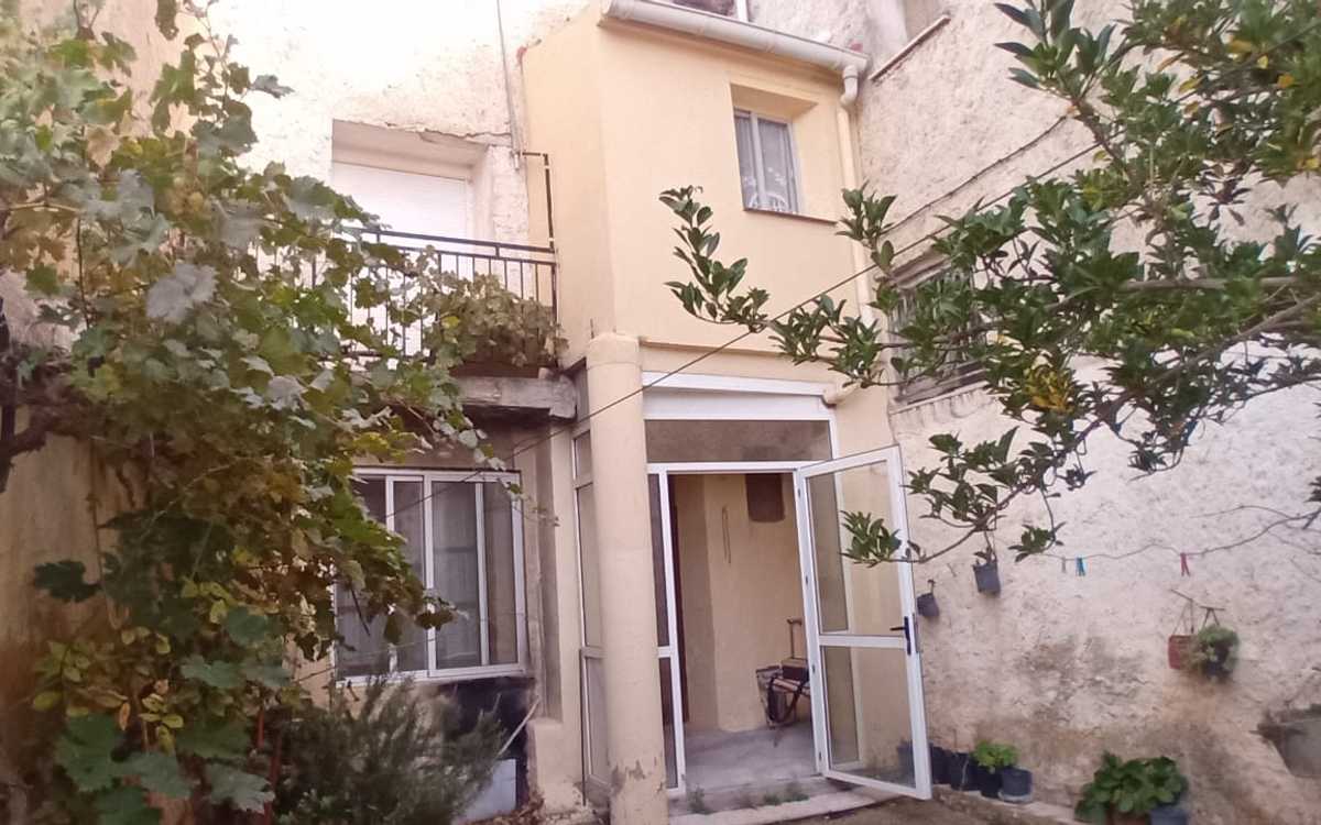 Double village house, separated by a patio.